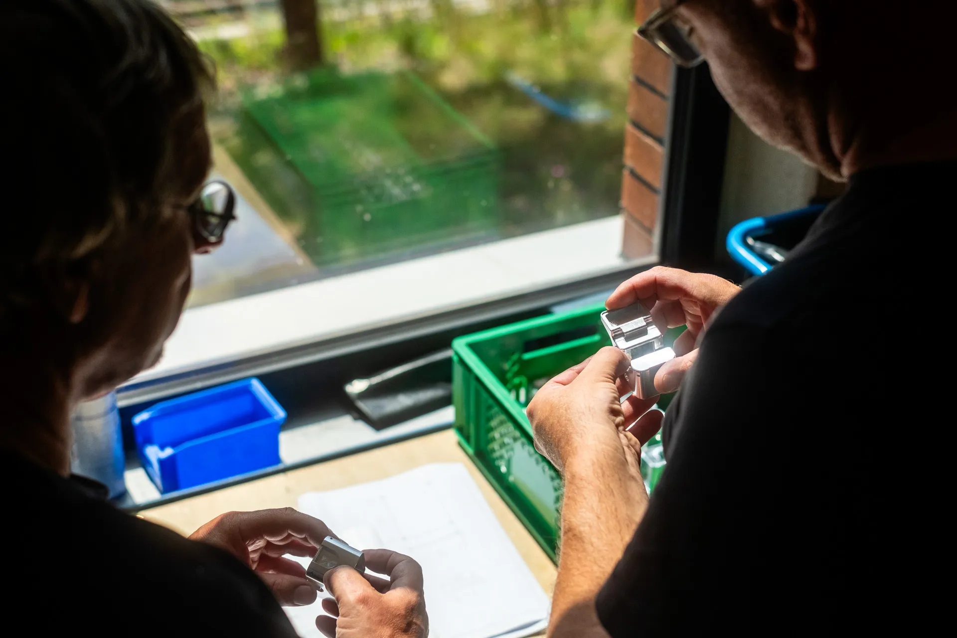 Sichtprüfung eines CNC-gefertigten Bauteils im Team am Arbeitsplatz